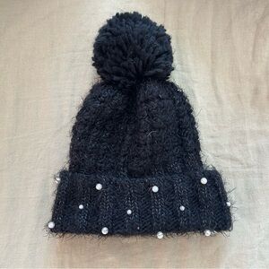Black knit hat with pom pom and pearls